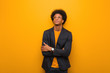 © Asier - Young business african american man over an orange wall tired and bored