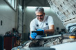 © cherryandbees - worker holding tablet in car service