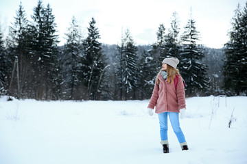 Wall Mural - Beautiful woman at snowy resort