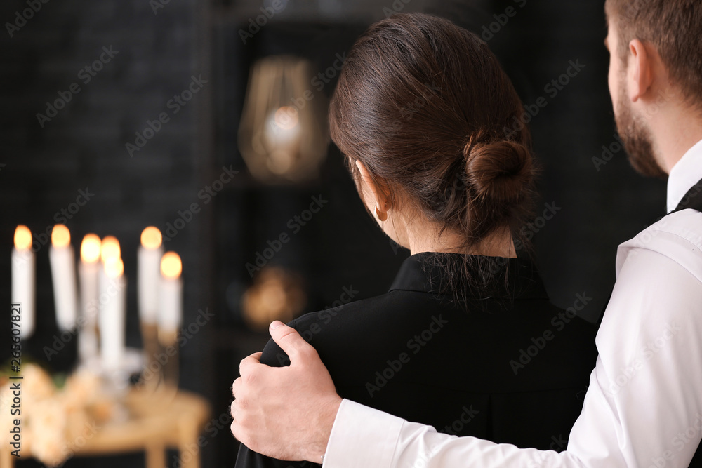 Couple pining after their relative at funeral - obrazy, fototapety, plakaty 