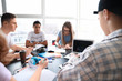 © Pixel-Shot - Group of teenagers studying together in school