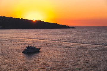 Luxury cruise ocean liner ship sailing from port on sunrise, sunset, Italy Sorrento bay, travel tour, work on the ship, vacancies, service, rest and holiday on the ship, space for text, Italy