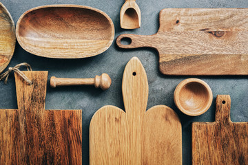 Wall Mural - Creative layout set of wooden kitchen utensils, cutting boards, bowl, plate, mortar and pestle, scoop. Flat lay, top view.