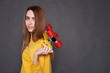 © Kiryl Lis - Portrait of positive young attractive girl wearing yellow blouse and blue jeans holding yellow skateboard.