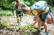 © BalanceFormCreative - Mother and her little sons hiking trough forest .Boy using magnifying glass and looking at insects.