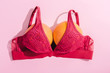 top view of bra with two oranges on pink, breasts concept