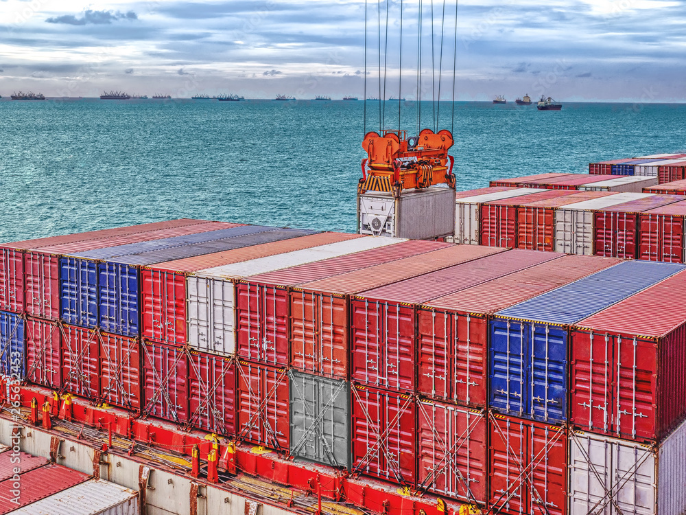 Industrial port crane lift up loading export containers box onboard ...