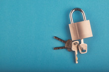 Locked Padlock And Bunch Of Key On The Blue Background.copy Space For Text