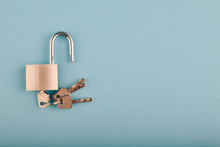 Unlocked Padlock And Bunch Of Key On The Blue Background.copy Space For Text