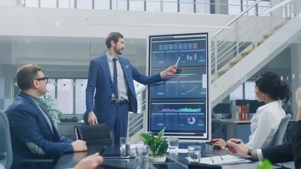 Wall Mural - In the Corporate Meeting Room: Ambitious Executive Uses Digital Interactive Whiteboard for Presentation to a Board of Directors Lawyers Investors. Screen Shows Company Growth Data with Animated Graphs