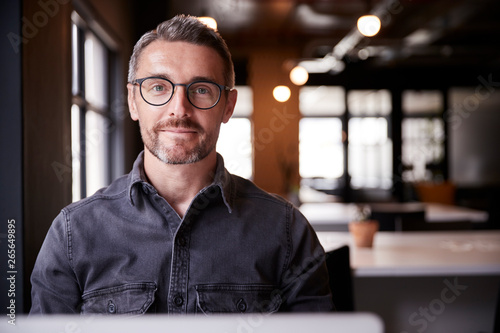 Middle aged white male creative sitting in an office smiling to camera, head and Poster Mural XXL