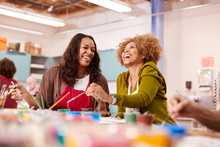Two Mature Women Attending Art Class In Community Centre Together