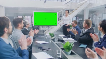 Wall Mural - In the Corporate Meeting Room: Female Executive Uses Digital Chroma Key Interactive Whiteboard for Presentation to a Board of Directors, Lawyers, Investors they Applaud. Green Mock-up Screen