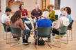© Monkey Business - People Attending Self Help Therapy Group Meeting In Community Center