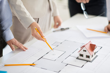 Sticker - architecture, construction business and people concept - close up of architects discussing blueprint of house project at office