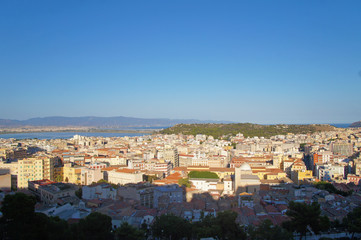 Cityscape view from above on the old medieval European Italian city with red roofs in the summer in the sun.