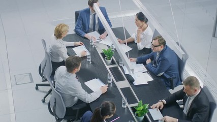 Wall Mural - In the Corporate Office Meeting Room Group of Businesspeople, Investors, Executives and Members of the Board of Directors Talking, Negotiating and Working on a Winning Strategy High Angle Camera Shot 