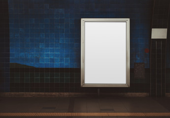 Wall Mural - An empty ad vertical poster template on a metro platform; blank information banner placeholder indoors; a subway or a train station with a white billboard on a blue tile wall with a copy space area