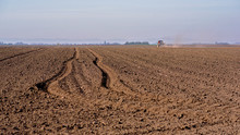 Tractor Spraying A Soil With Fertilizer. Fertilization Of Soil. Early Spring Time.