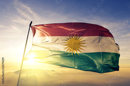 Valokuva  Kurdistan flag waving on the top sunrise mist fog