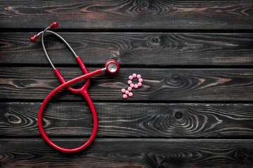 diagnostic and cure of gynaecological disease with stethoscope and female symbol on wooden background top view mock-up