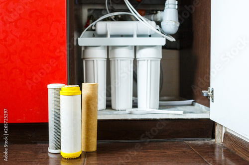 It\'s time to change water filters at home.  Replace filters in water purifying system. Close up view  of three used filters. Clean water at home