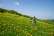 © Werner - Fahrrad Fahrerin macht Pause , mitten in blühender Frühlingswiese