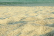 Sea sand as background, space for text. Summer backdrop