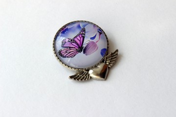 Wall Mural - metal brooch with butterfly on white background