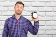 © fotofabrika - man holding an alarm clock