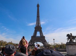 Eiffel Tower in Paris France against blue sky with clouds. View from a tourist bus. April 2019