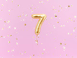 Fototapeta  - Seven year birthday. Number 7 flying foil balloon on pink. Seven-year anniversary gold confetti background. 3d rendering