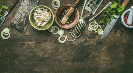 Kitchen utensils on rustic wooden background with fresh seasoning, BBQ simple marinade, top view. Copy space.