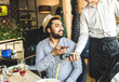 © xartproduction - Young attractive Hindu man paying in cafe with contactless smartphone payment