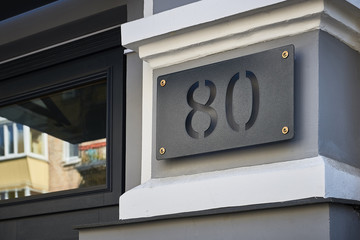 street sign with house number 80