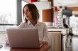 © Milana - Beautiful  young woman is working on her lap top in the coffee shop