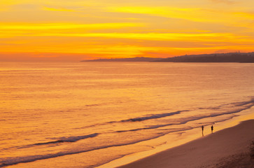 Wall Mural - Picturesque bright golden sunset on the sandy seashore of the Atlantic Ocean. Natural summer background. Beautiful beach landscape. View from above..
