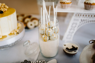 Wall Mural - Colorful table with sweets and goodies for the wedding party reception, decorated dessert table. Delicious sweets on candy buffet. Dessert table for a party. cakes, cupcakes. Beautiful cake pops.