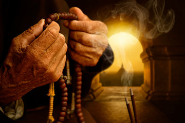 Hands with Buddhist prayer beads