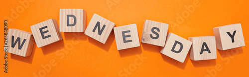 panoramic shot of wooden cubes with letters on orange surface