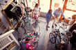 © luckybusiness - Seller helping customers to choosing new bicycle in store top view.