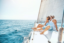 Young Man And Woman Relaxing On A Yacht..