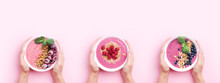 Hands Holding Smoothie Bowls On Pink Background. Three Smoothie Variants Of Breakfast. Top View.