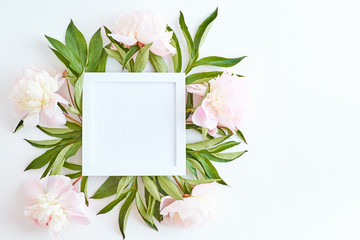 Wall Mural - mockup square white frame with light pink peonies on a white background
