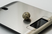 One Quail Egg Lies On The Table Scales. The Background Of The Image Is White. Selective Focus. Copy Space. Concept: Diet Food.