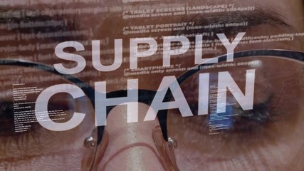 Supply Chain text on the background of female software developer. Eyes of woman with glasses are looking at programming network code space abstract technologies connecting global data network