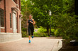 © Cavan Images - An athletic woman runs along a brick path in Boston.