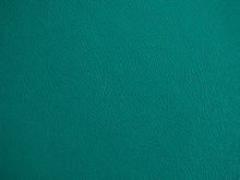 Close-up Of Teal Woven Fabric Leather Plastic Textile Lattice Or Grid Surface Texture. Crossover Lines. A Lattice Work Of Interwoven Green Plastic Textile Textured Strips Forms A Pattern Background