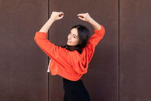 Young Contemporary Dancer In Front Of A Rusty Wall Dancing And Looking At Camera