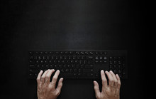 Top View, Hand Typing Computer Keyboard On Black Background